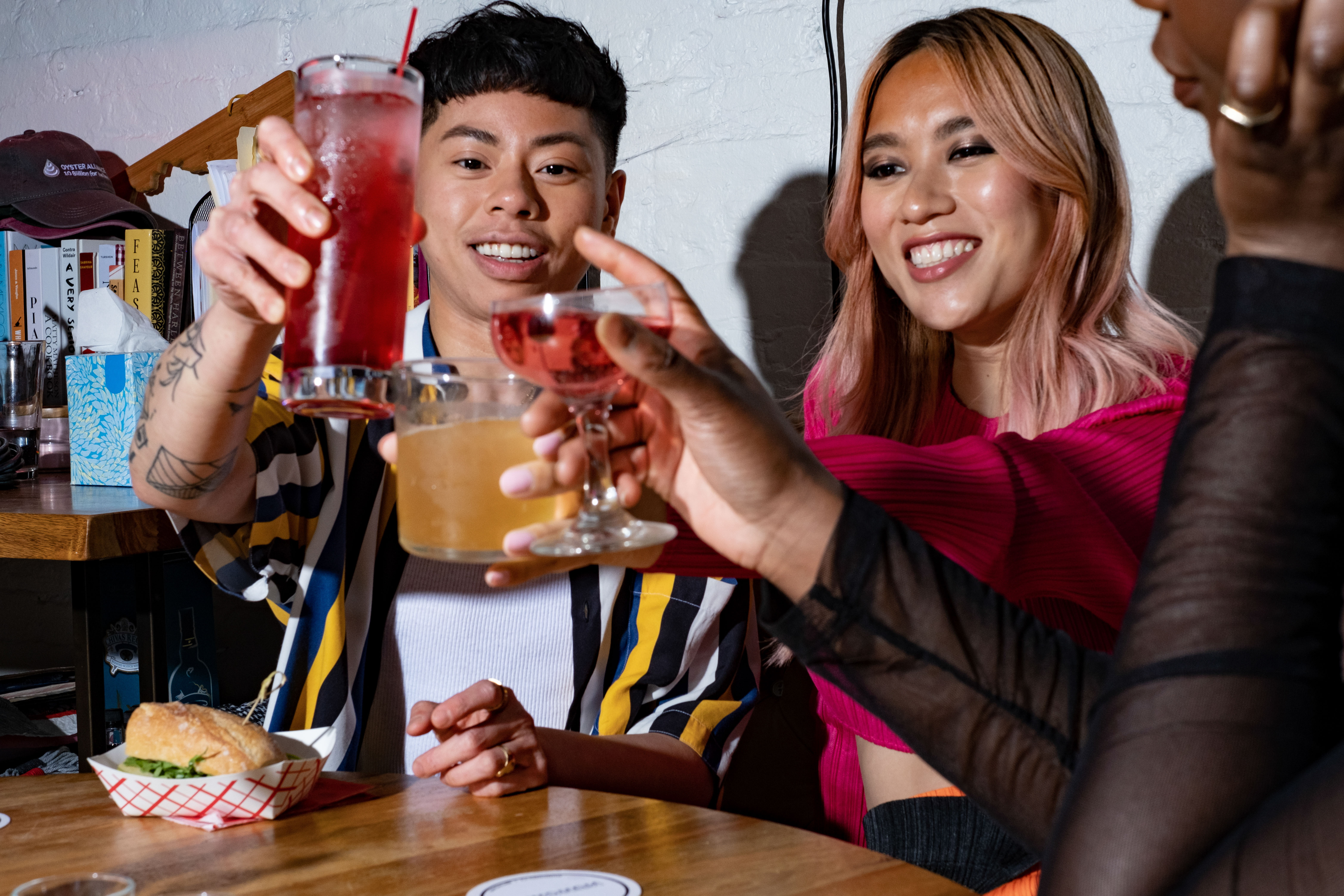 A group of friends of varying genders making a toast